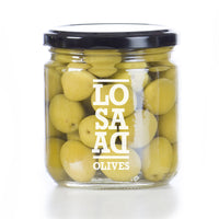 Manzanilla Olives, Aceitunas Manzanilla.These green olives from Seville, Spain have a balanced taste between bitterness and saltiness with a slight almond flavor. Manzanillas, the most widely used table olive in Spain, have a firm and meaty texture. They are often enjoyed in a martini and pair well with Spanish cheeses, such as Manchego.