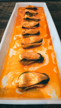 Mussels in Pickled Sauce served on white plate